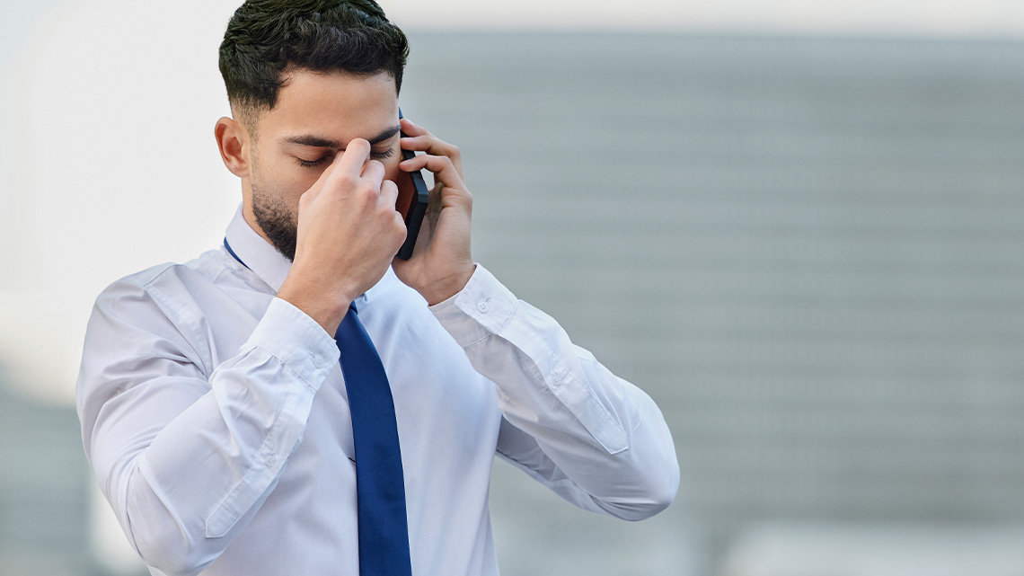 Businessman frustrated and on the phone.