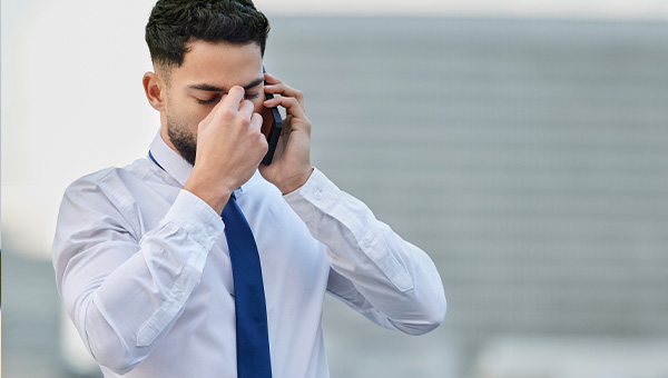 Businessman frustrated and on the phone.